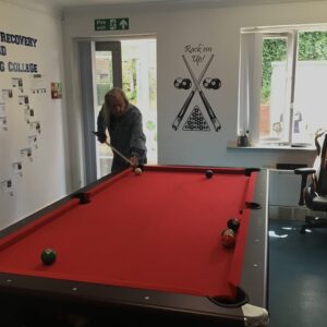 male resident playing pool