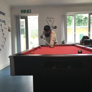male resident playing pool