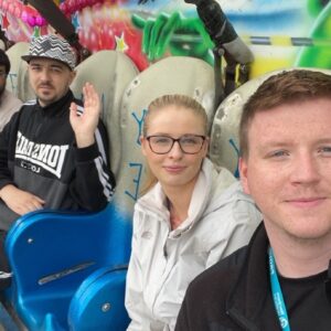 residents and team members on fairground ride