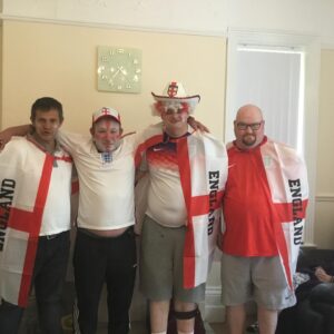 life at Glen Garth: residents dressed in england tops, facepaint and hats