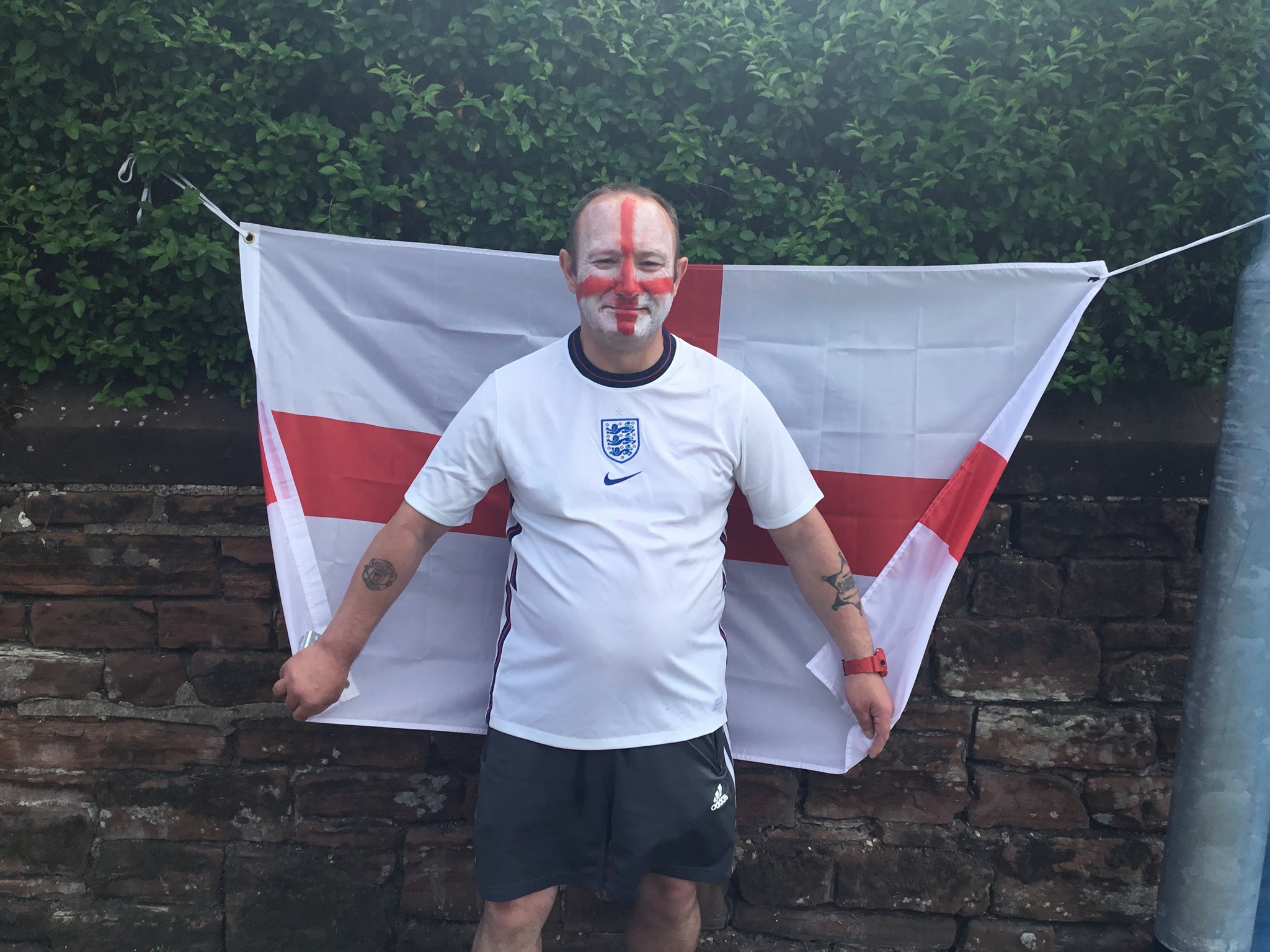 Life at Glen Garth: resident stood in front of england flag wearing england top and england flag painted on face