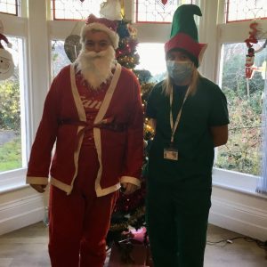 resident and team members dressed as santa and an elf