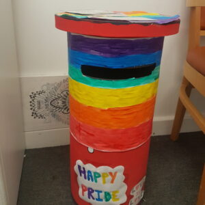 Roud post box decorated for Pride