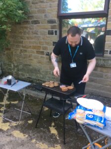 service manager cooking on bbq