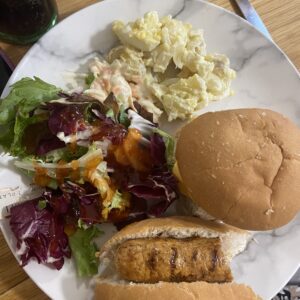 plate with burgers, hot dogs and salad