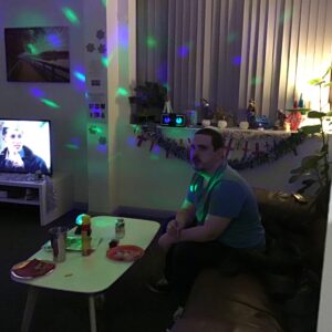 resident watching tv with green and purple sensory lights