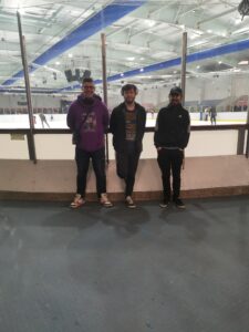 3 males outside ice rink