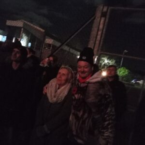 residents outdoors wrapped up warm watching fireworks