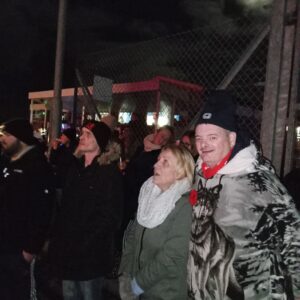 residents outdoors wrapped up warm watching fireworks