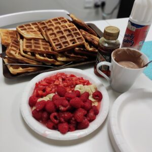 plate of waffles and plate of raspberries