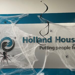 Holland House sign covered in fake cobwebs