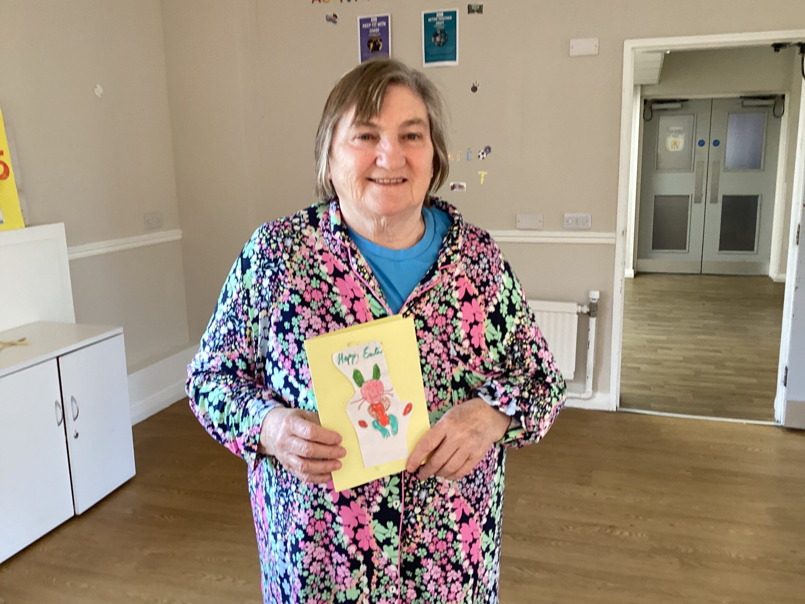 Resident holding a homemade Easter card