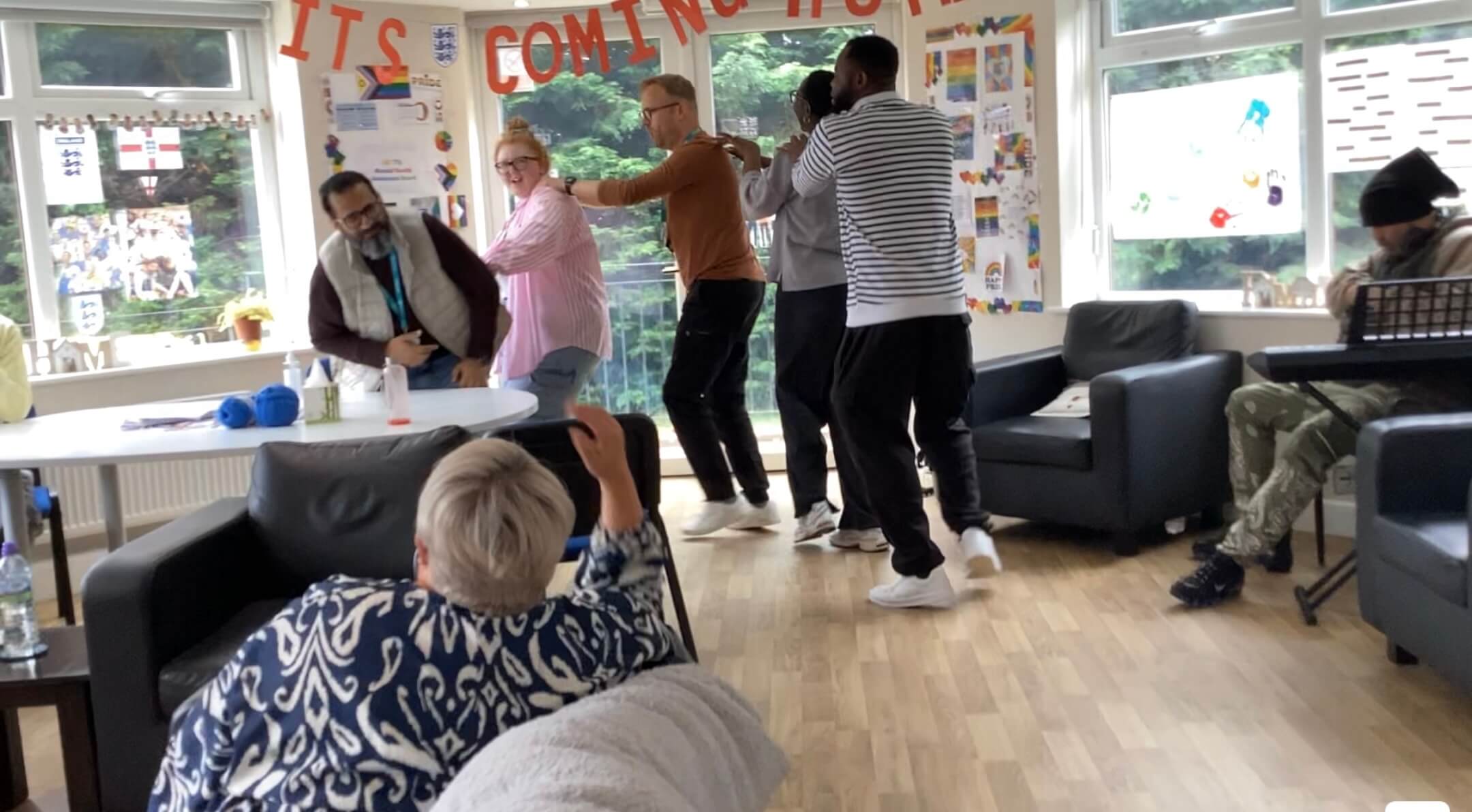 Group of people participating in Inclusion conga line
