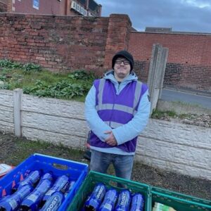 resident volunteering at street kitchen