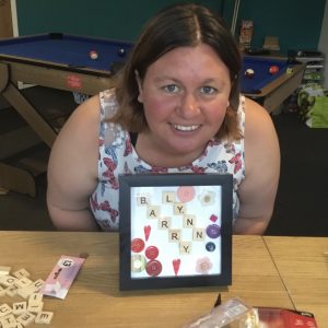 resident posing with handmade personalised frame