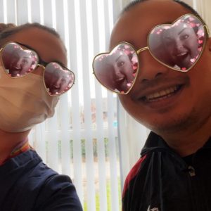 resident and team member wearing heart shaped sunglasses