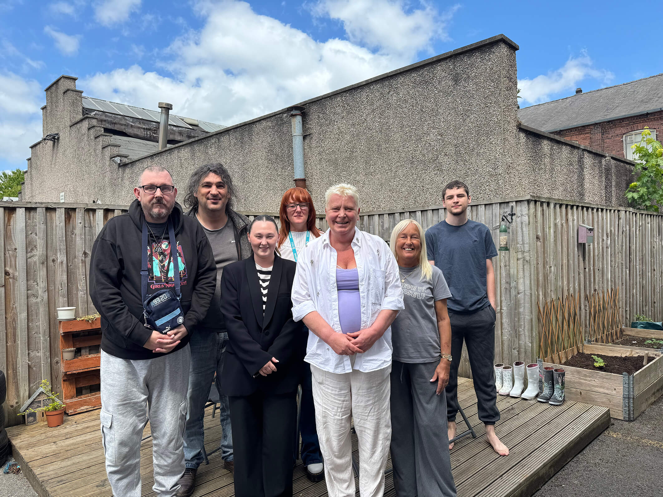 Staff and the people we support at Montgomery House in Bury, Greater Manchester, together in the process of renovating their garden.