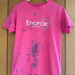 A photo of an Encircle Housing shirt, showing hard work from the garden makeover project.