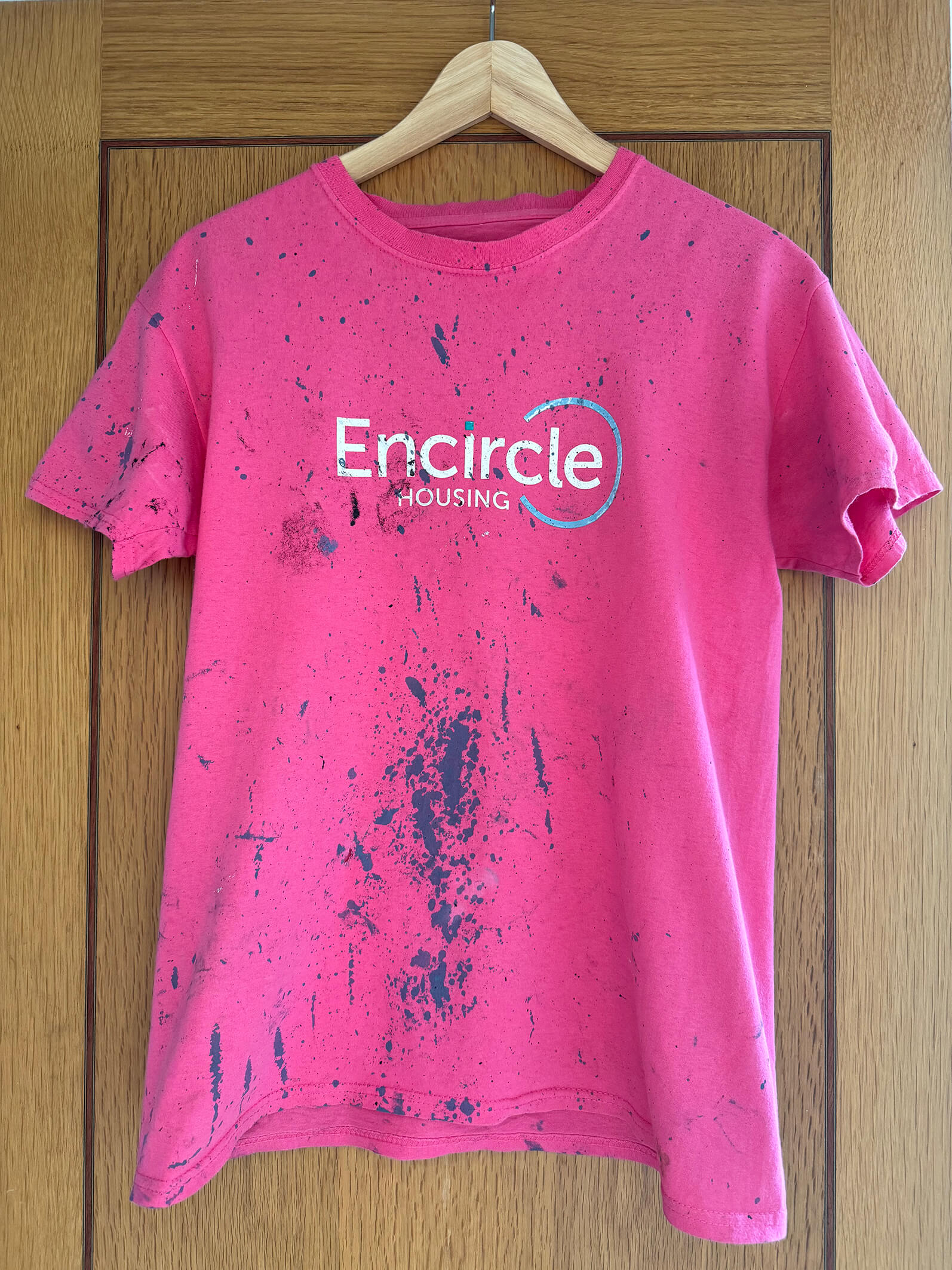 A photo of an Encircle Housing shirt, showing hard work from the garden makeover project.
