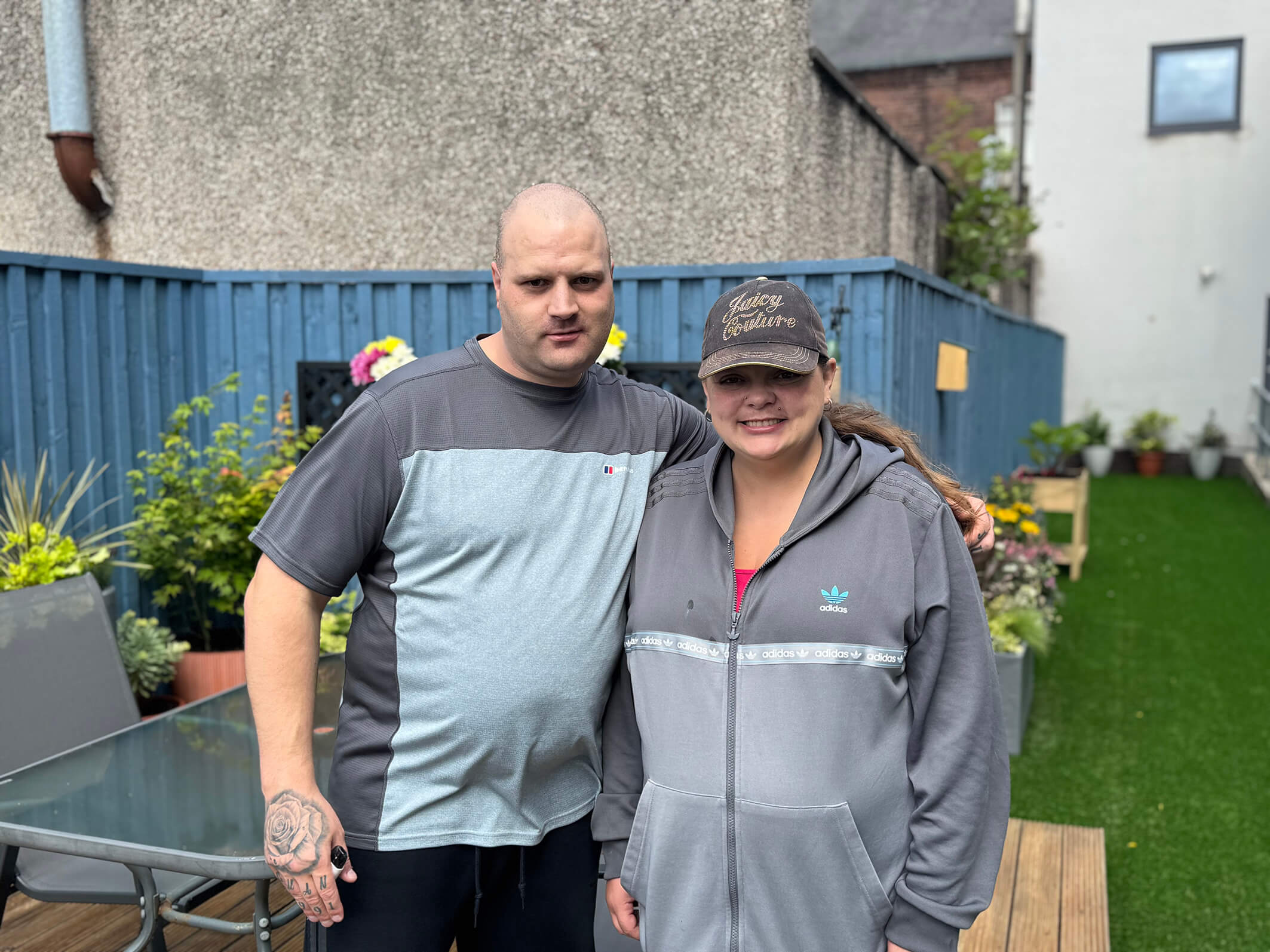 Two people we support at Montgomery House in Bury, Greater Manchester, pausing for a photo during the garden renovation.