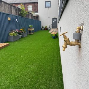 The final result of the garden makeover and renovation at Montgomery House in Bury, Greater Manchester, showing a new grassy area.