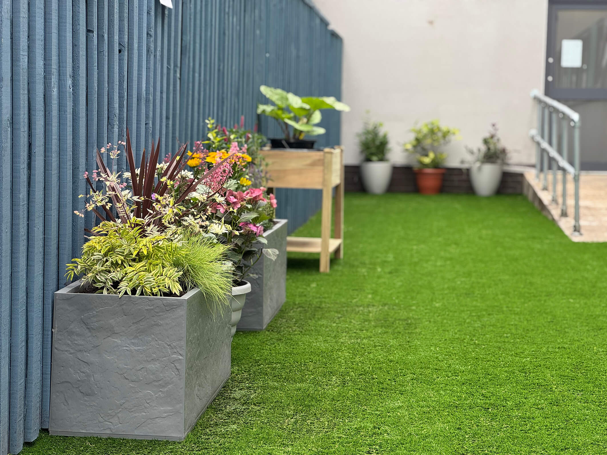 The final result of the garden makeover and renovation at Montgomery House in Bury, Greater Manchester, showing lovely raised flowerbeds.