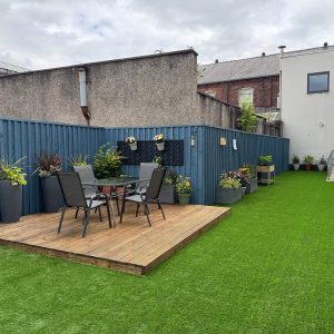 The final result of the garden makeover and renovation at Montgomery House in Bury, Greater Manchester, showing a new patio and garden area with furniture.