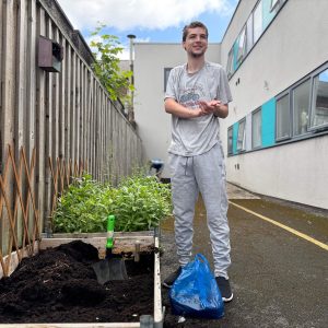 A person we support at Montgomery House in Bury, Greater Manchester, planning and creating his kitchen garden as part of a garden renovation.
