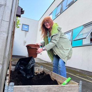 A staff member at Montgomery House in Bury, Greater Manchester, working hard on the garden renovation.
