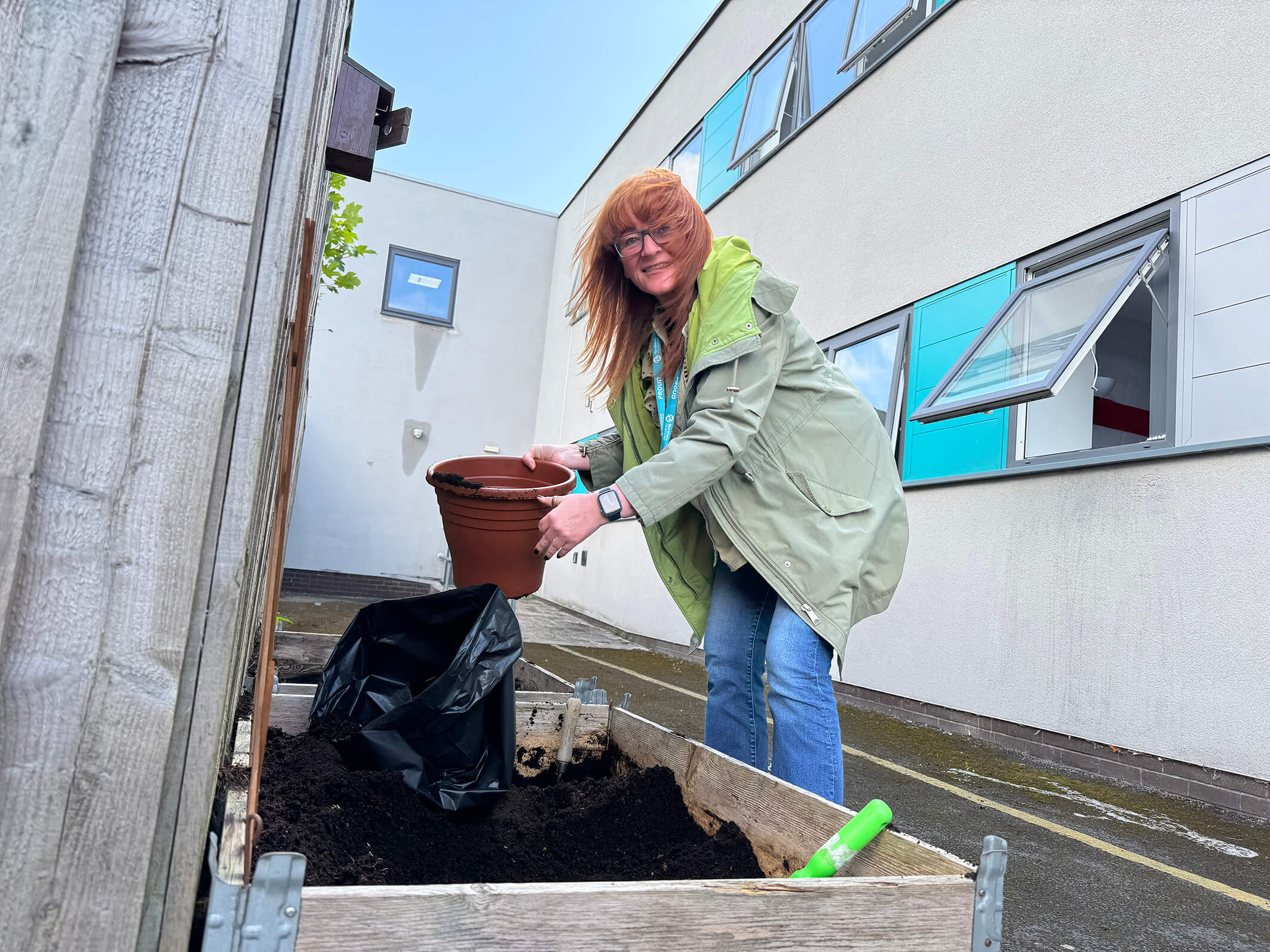 A staff member at Montgomery House in Bury, Greater Manchester, working hard on the garden renovation.