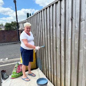 A person we support at Montgomery House in Bury, Greater Manchester, working hard on the garden renovation.