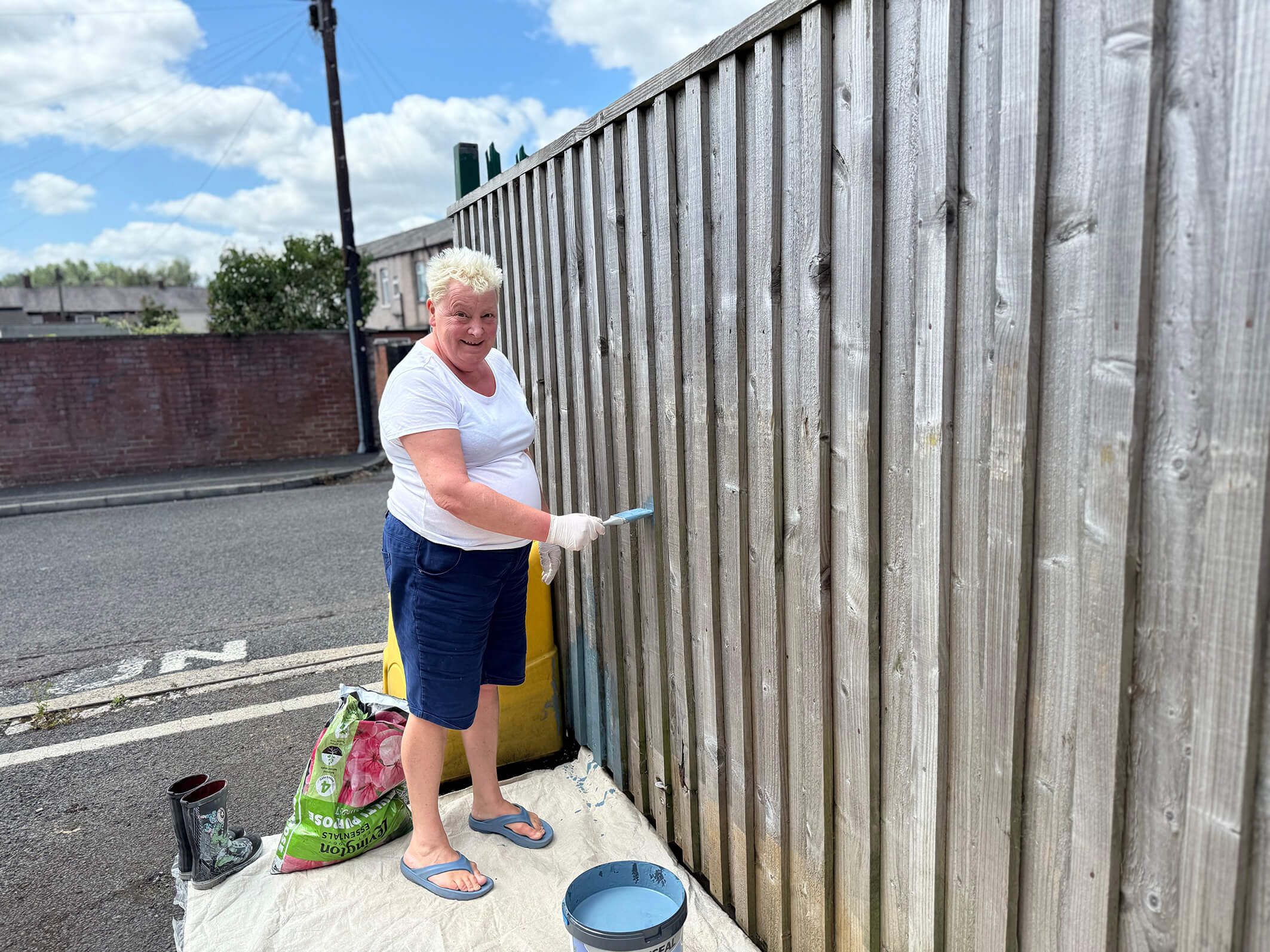A person we support at Montgomery House in Bury, Greater Manchester, working hard on the garden renovation.