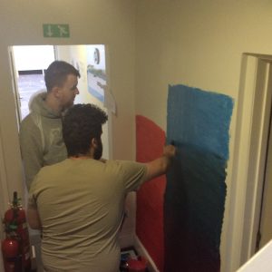 residents painting the wall mural