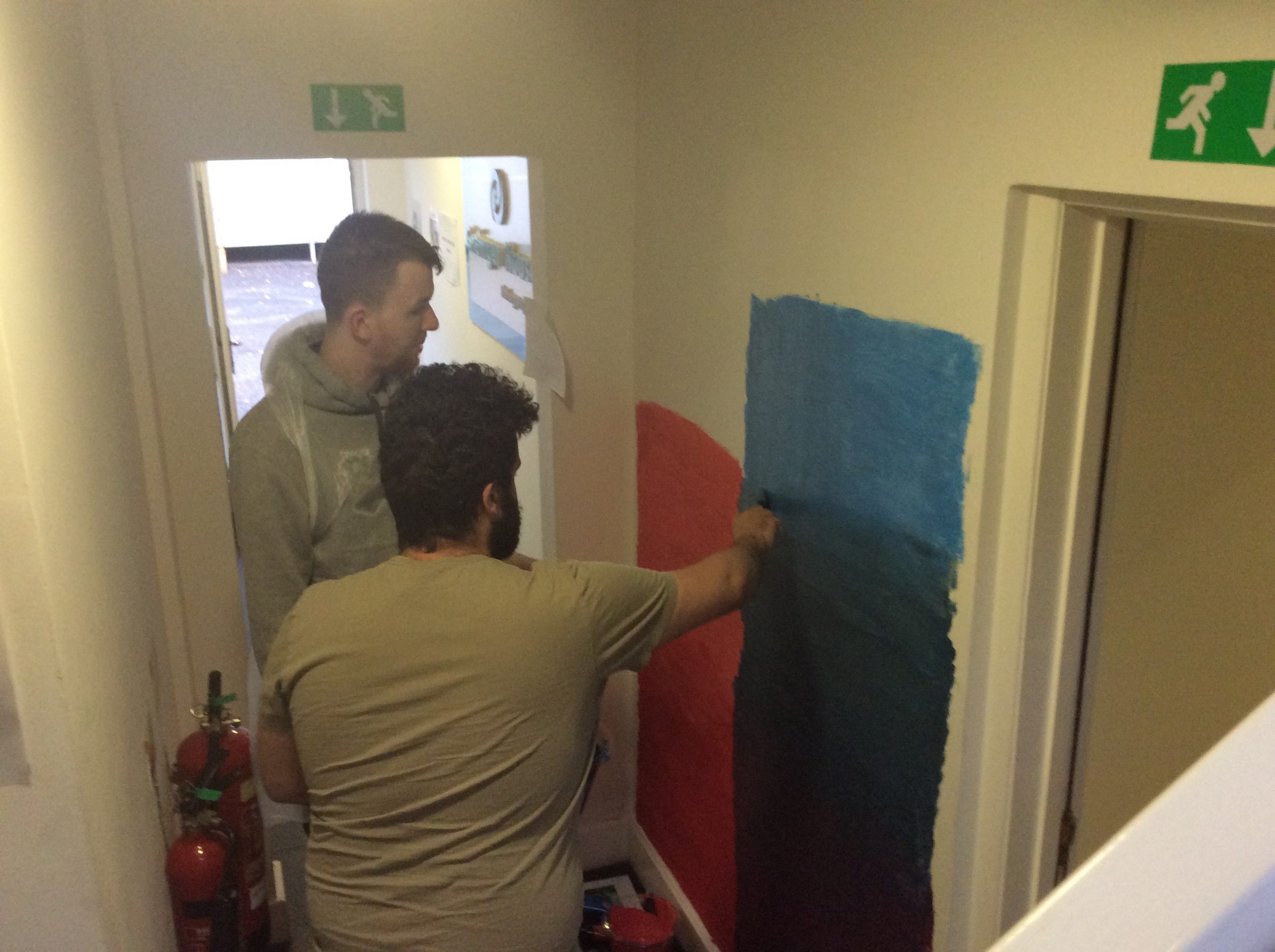 residents painting the wall mural