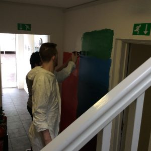 residents painting the wall mural
