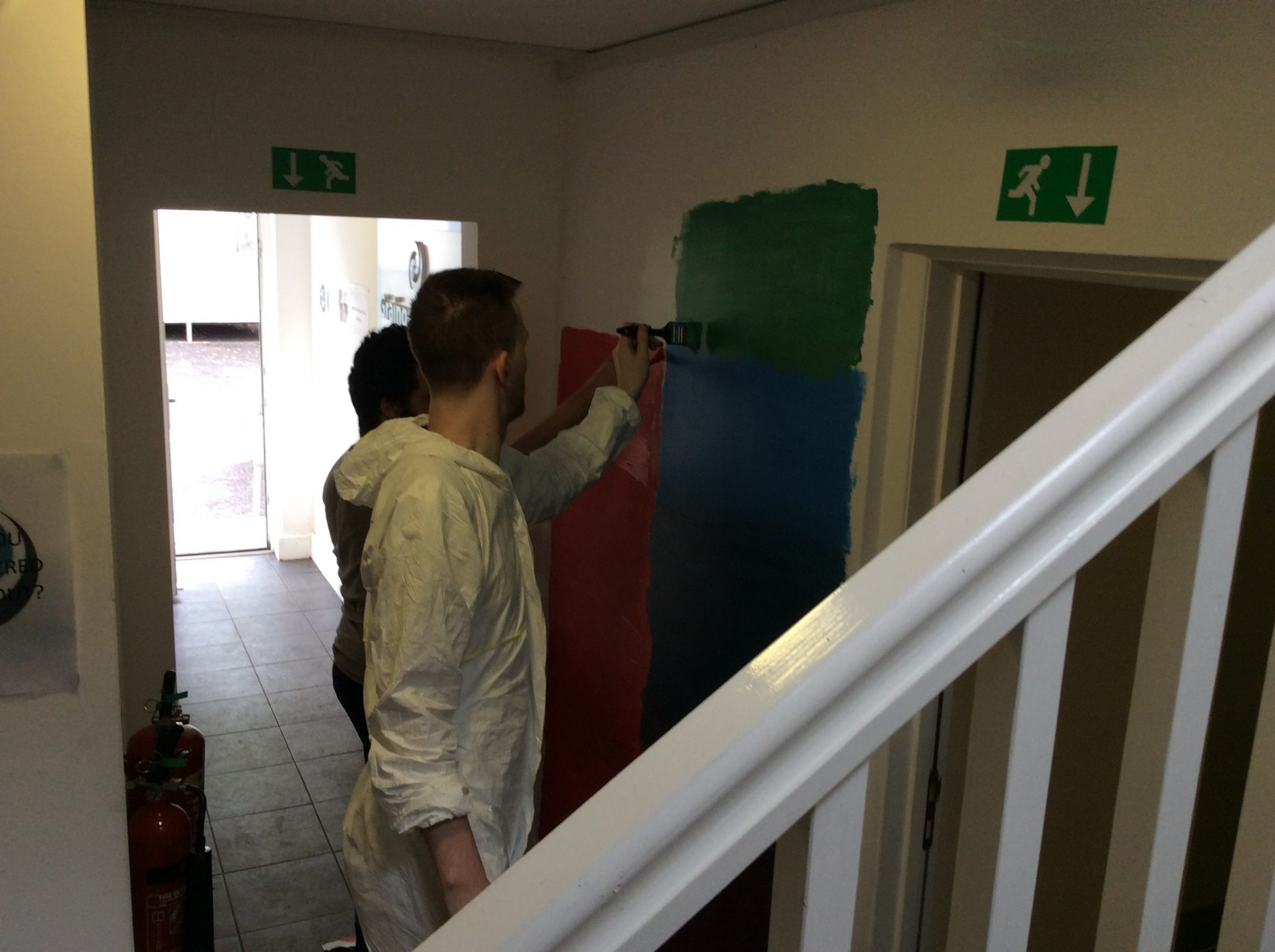 residents painting the wall mural