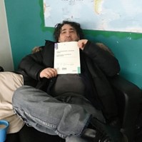 A resident receiving their certificate of study