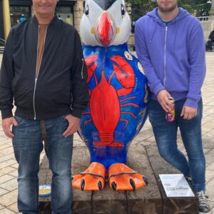 residents with puffin statue