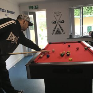 male resident playing pool