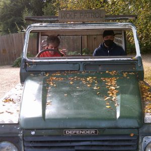 Hyde Park residents in a green jeep labelled Wolf Patrol