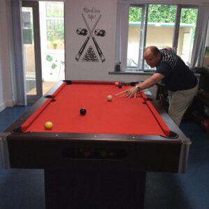 male resident playing pool
