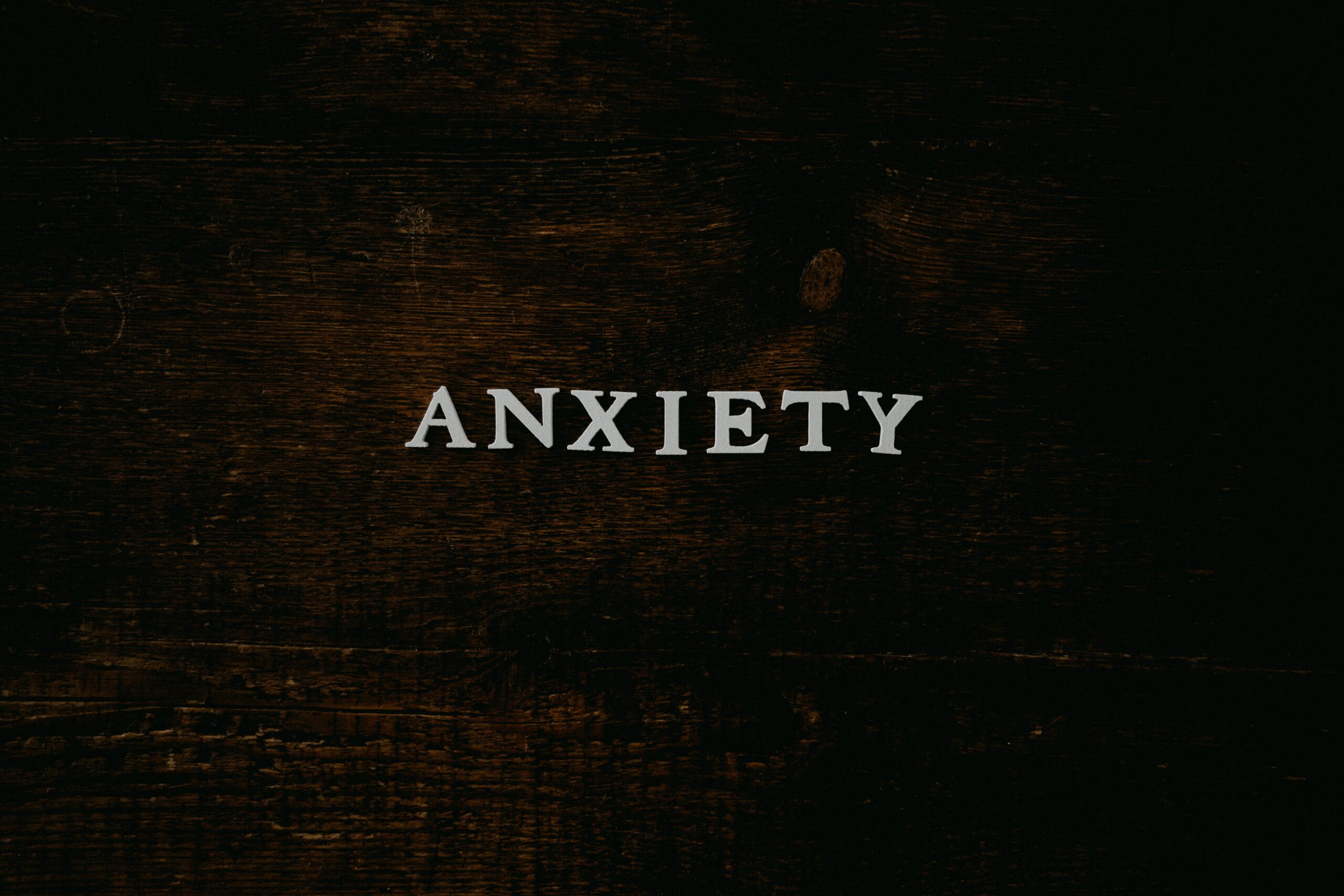 Managing anxiety - black background with the word "anxiety" in white typefont