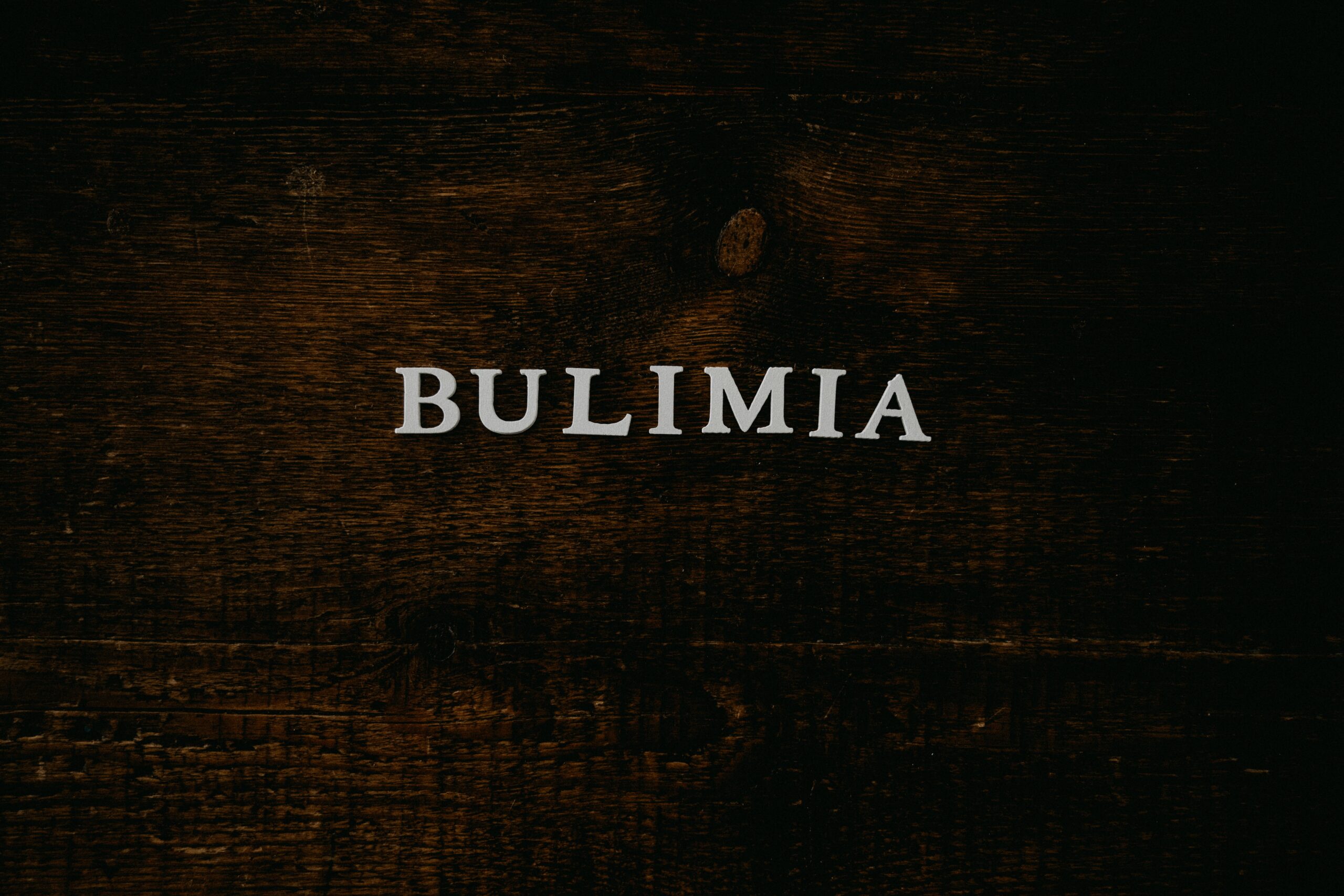 white letters spelling Bulimia on brown background
