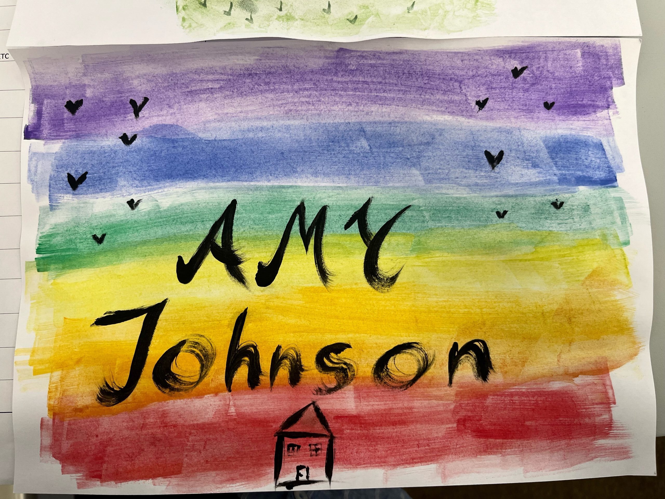 resident artwork: rainbow background with Amy Johnson written in black