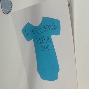 baby shower decoration blue tshirt drawing reads "welcome little one"