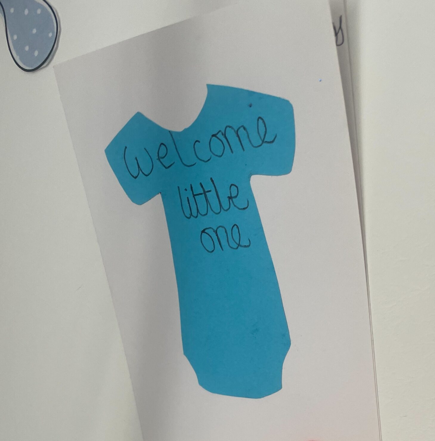 baby shower decoration blue tshirt drawing reads "welcome little one"