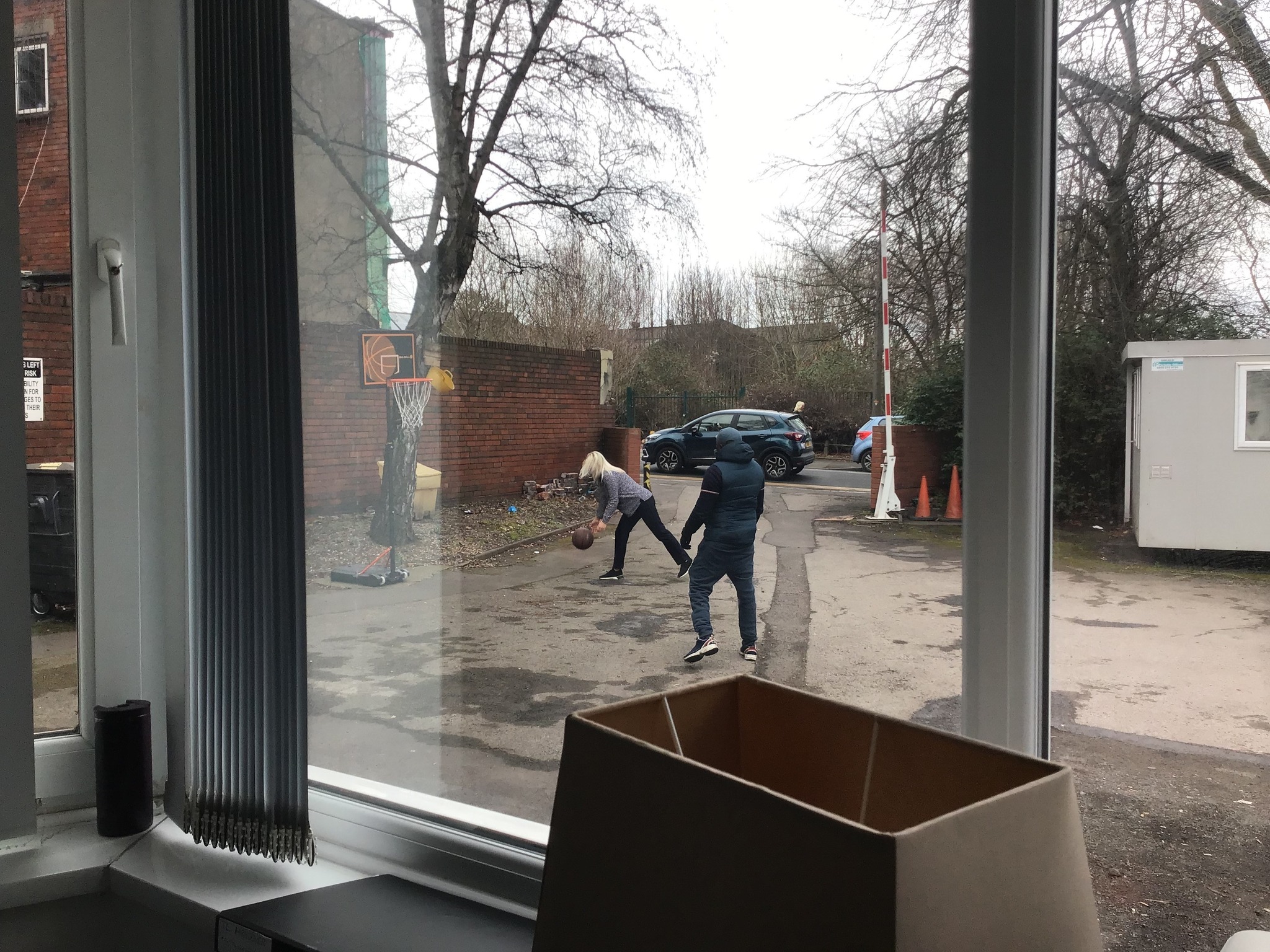 Male resident and female staff member shooting hoops