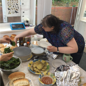 resident choosing food from buffet table