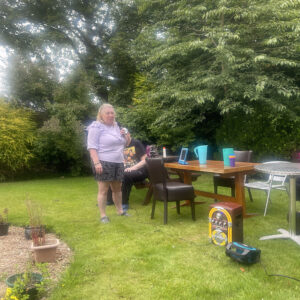 resident doing karaoke in the garden