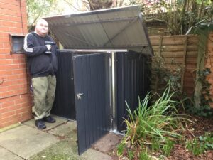 Resident stood next to bike shed